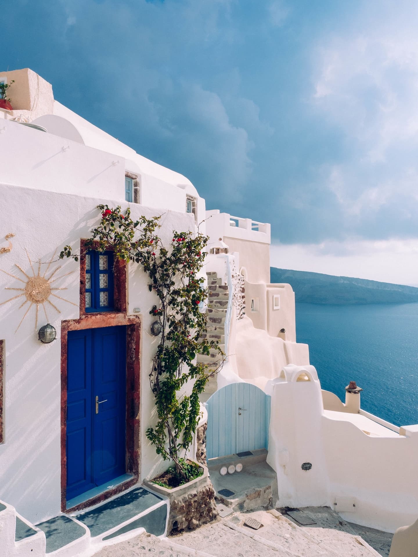 Blue door building with bougainvillea in Santorini