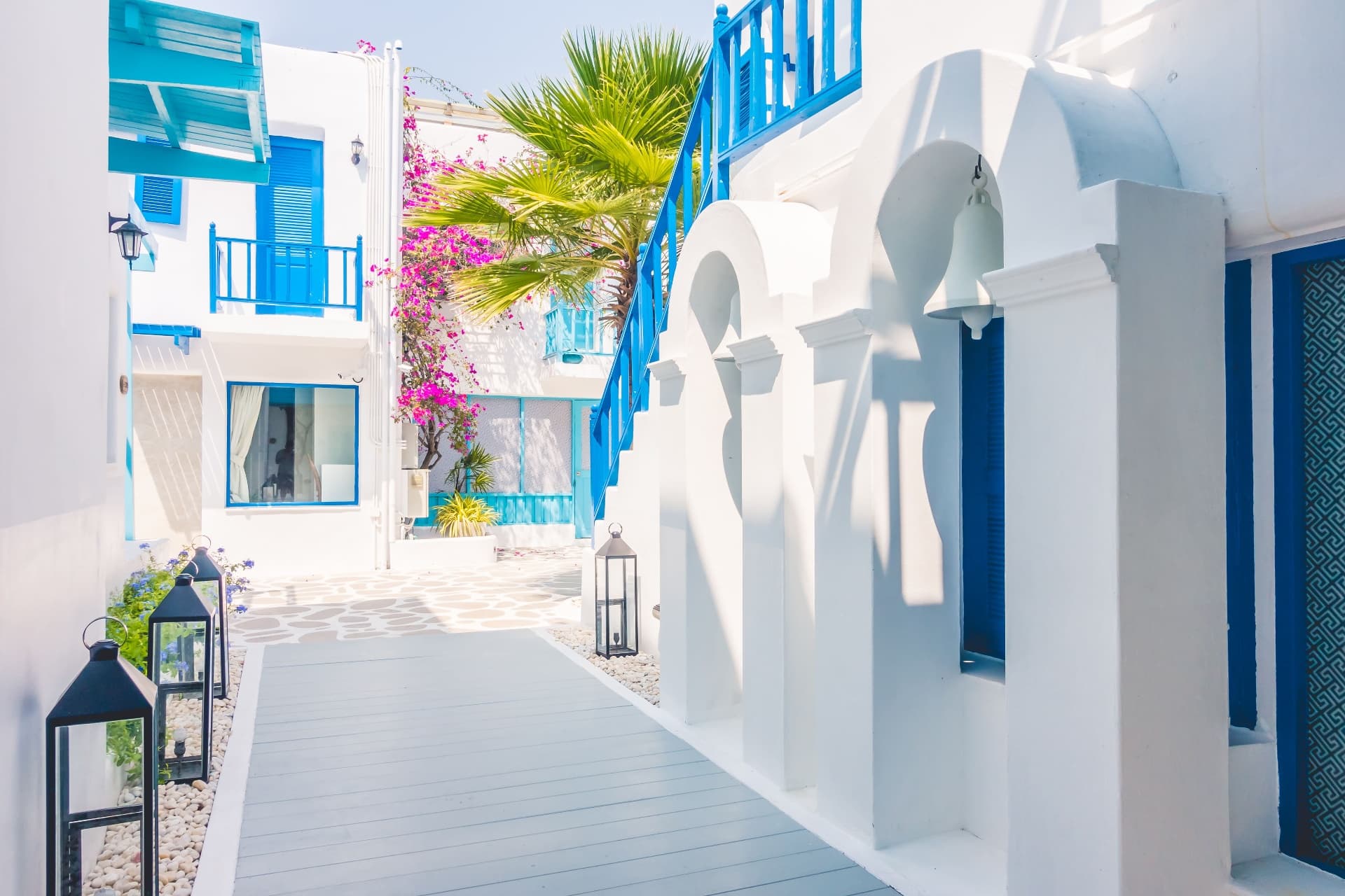 Santorini bougainvillea courtyard with blue shutters