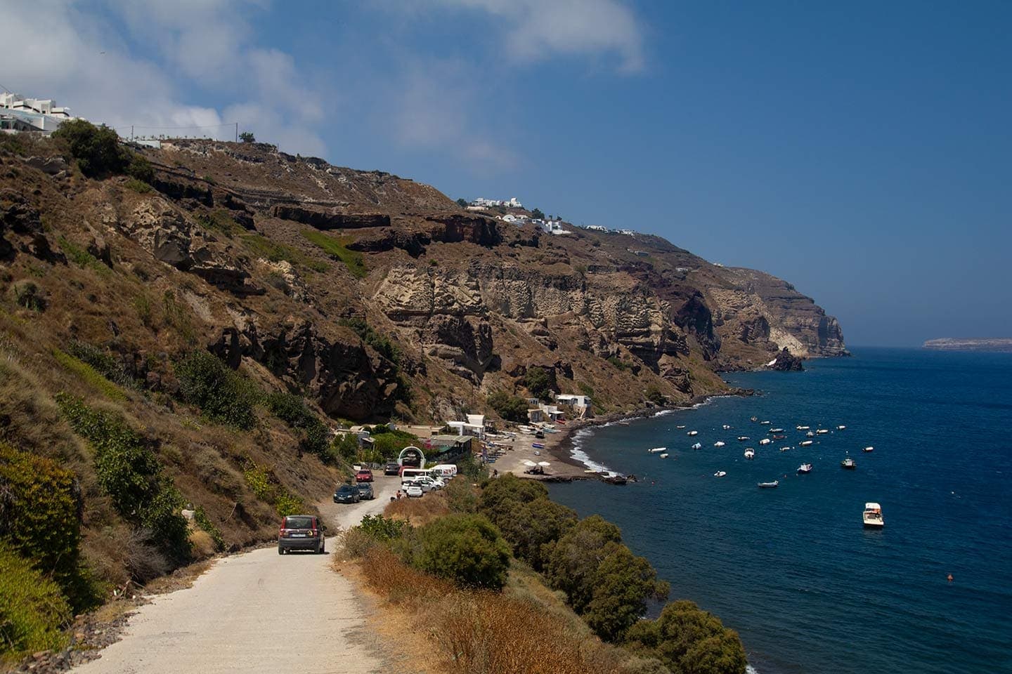 Santorini coastal road leading to a seaside village