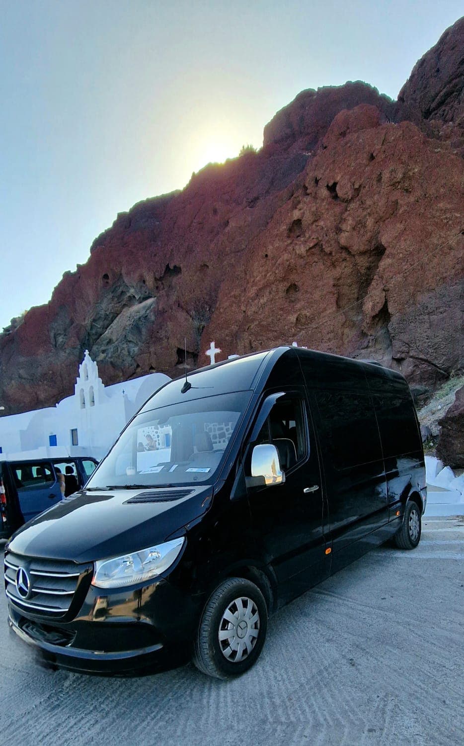 Mercedes Sprinter van at Red Beach cliff in Santorini