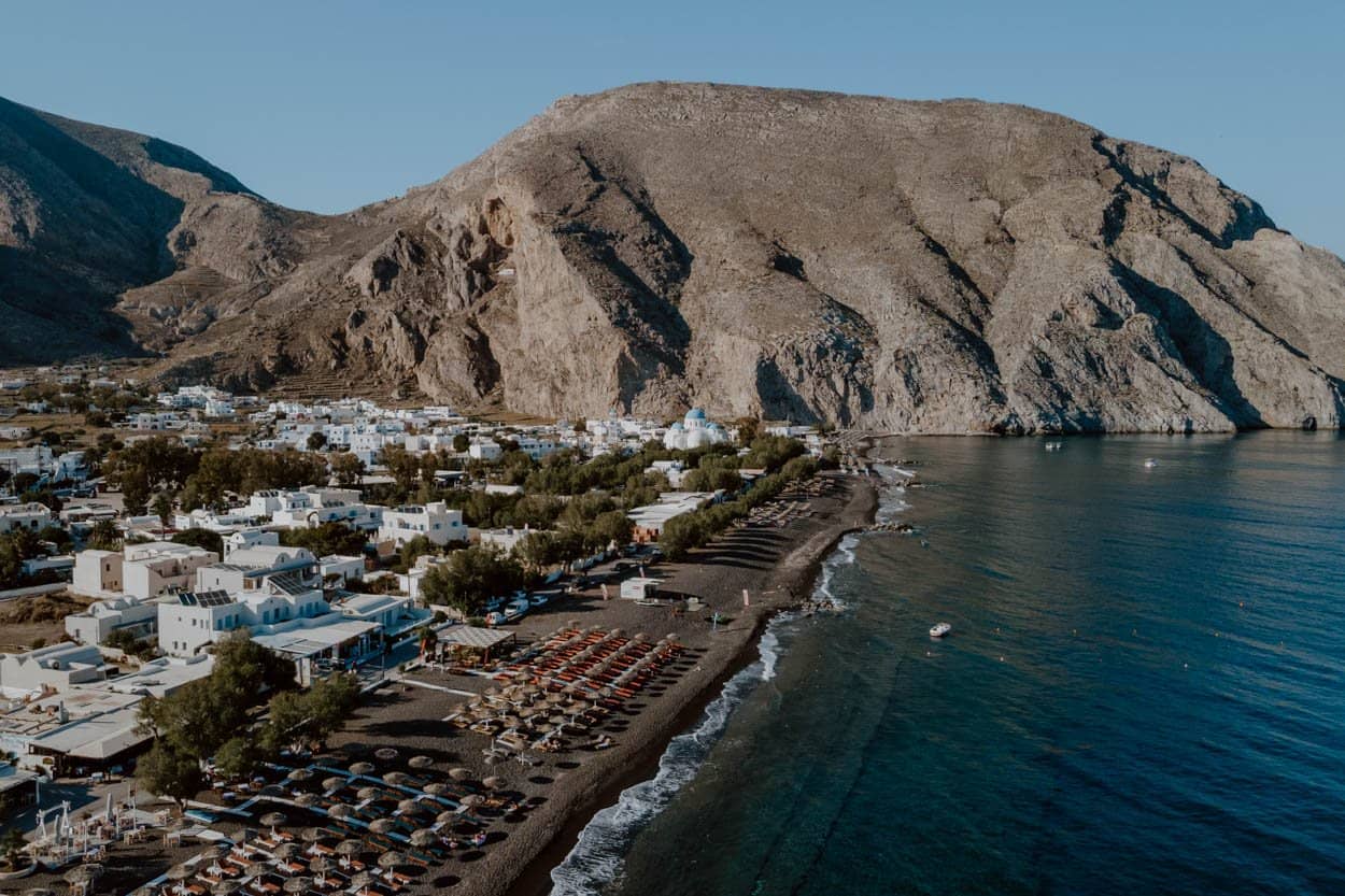 Perissa black sand beach with mountain backdrop