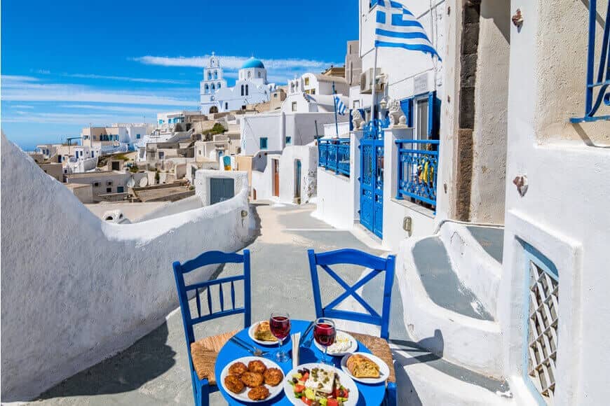 Traditional Greek lunch in Pyrgos village with blue dome church view