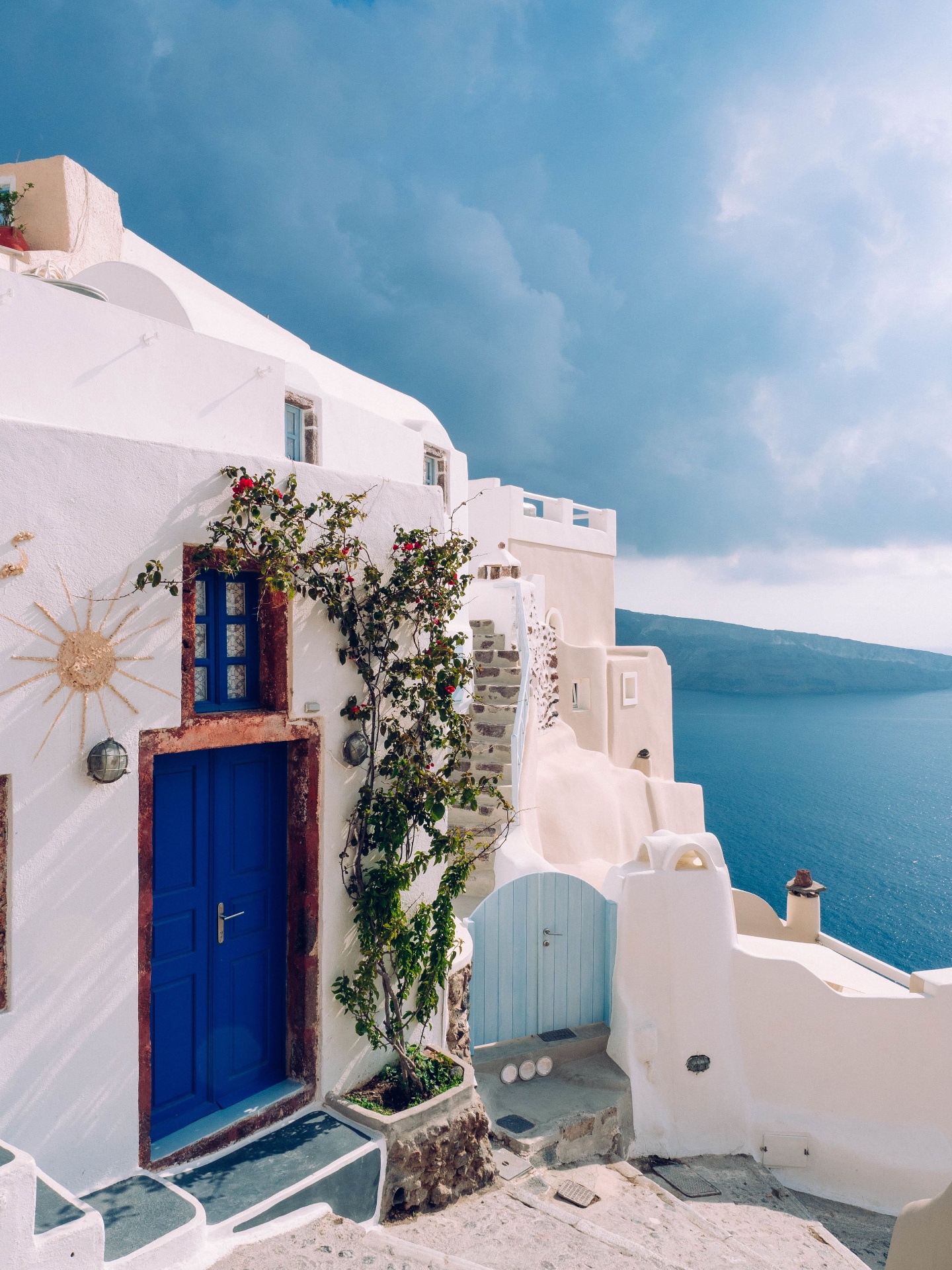 Blue door building with bougainvillea in Santorini